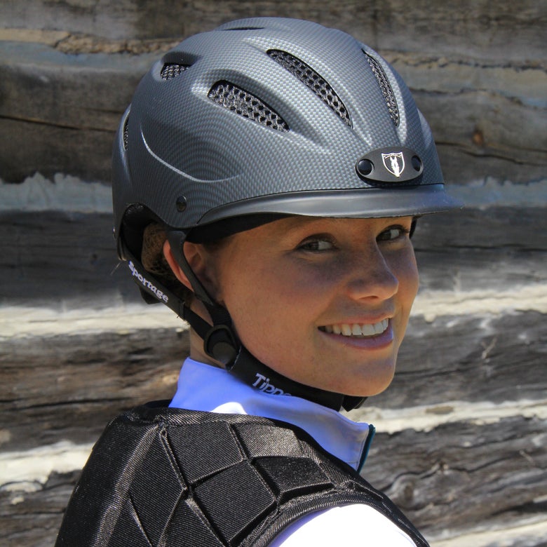 Woman wearing a Tipperary Sportage 8500 Riding Helmet and Tipperary Safety Vest.