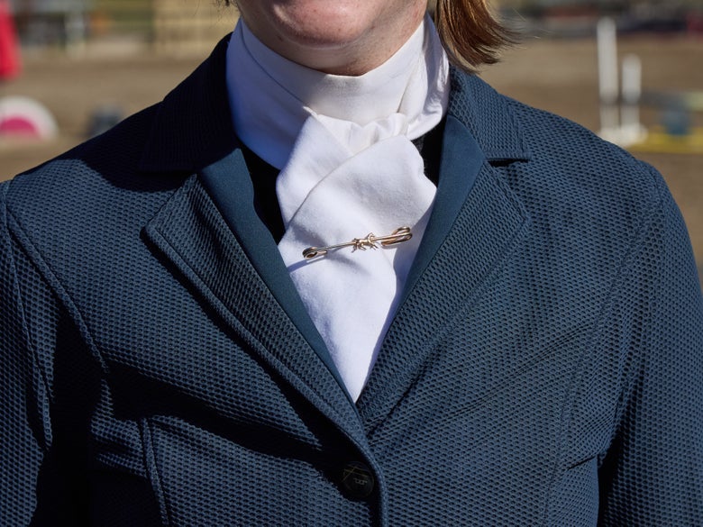 A women wearing a show shirt with a white stock tie.