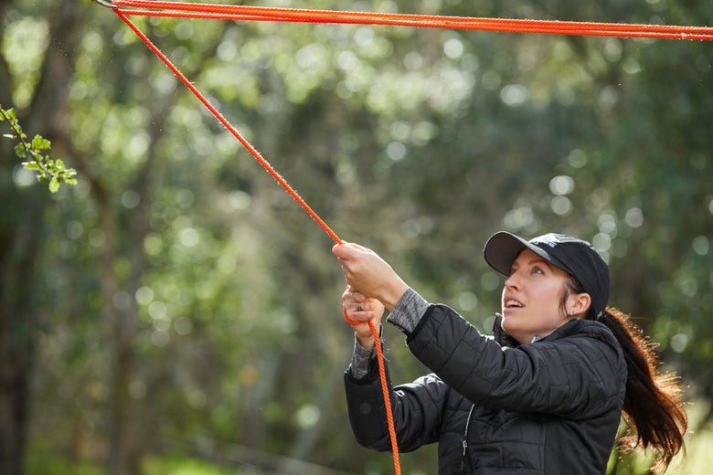 Gillian tightening her pulley system she created through one of the no-knot swivels and the second tree saver. 