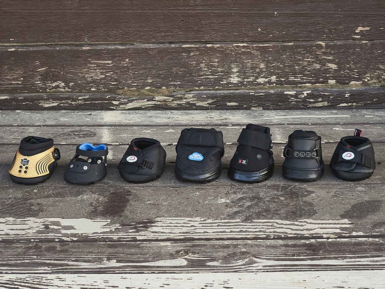 A row of different hoof boot brands and styles lined up side by side. 