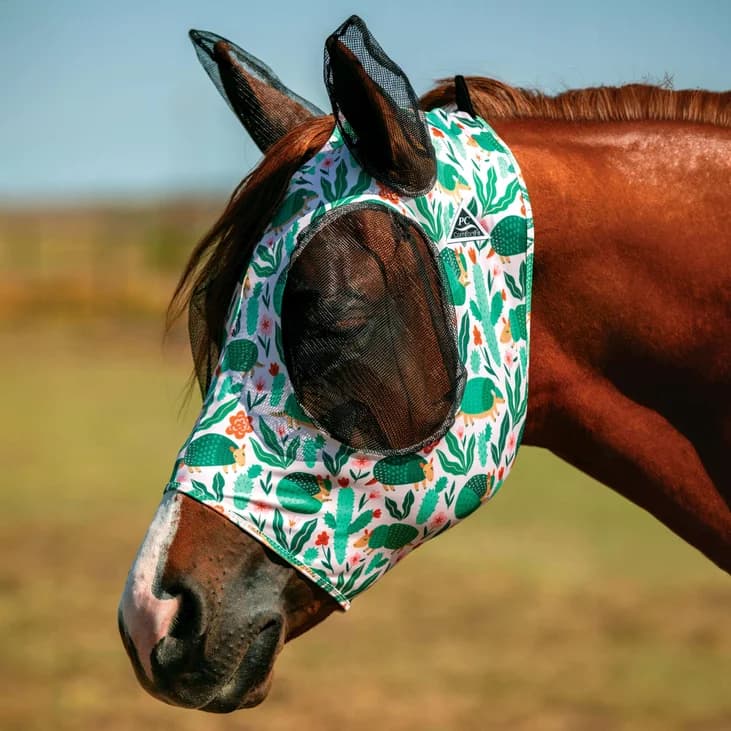 A chestnut horse wearing the Professionals Choice Patterned Fly Mask with Armadillo print.