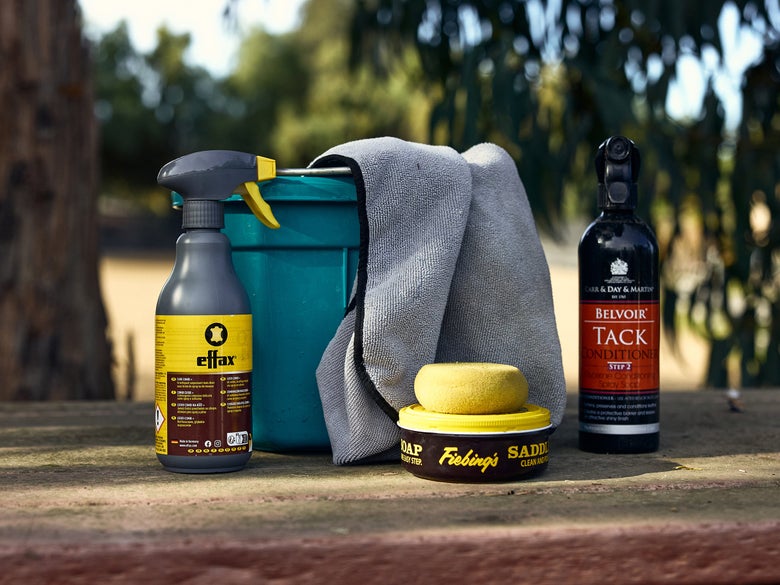 Tack cleaning supplies assembled on a table.