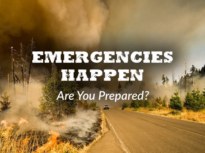 Truck driving on smoky road from forest fire