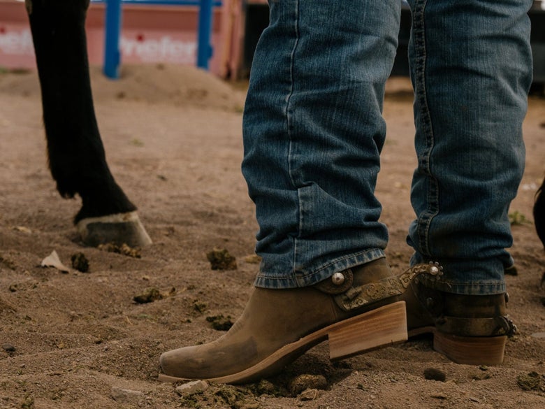 A cowboy wearing the HYER Hays Legends Cowboy Boots.