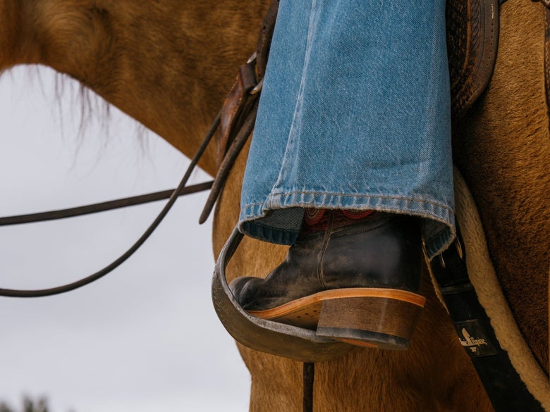 A cowgirl riding in the HYER Tipton WesTrail Boots