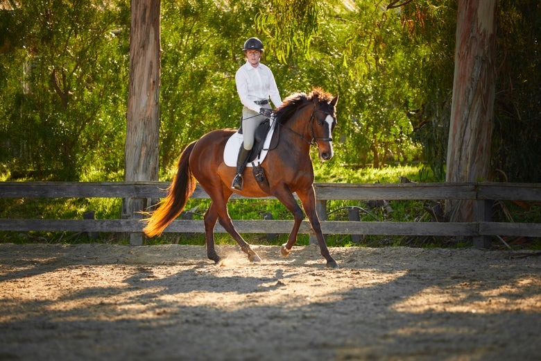 Girl standing next to her tacked up horse, wearing customized KEP Italia Cromo 2.0 Helmet. 