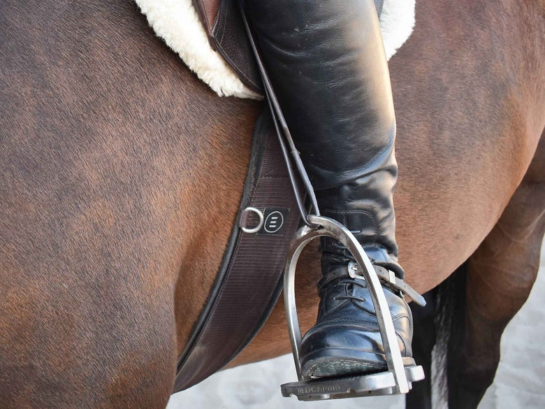A horseback rider using the MDC S Classic Aluminum Tread Stirrup Irons