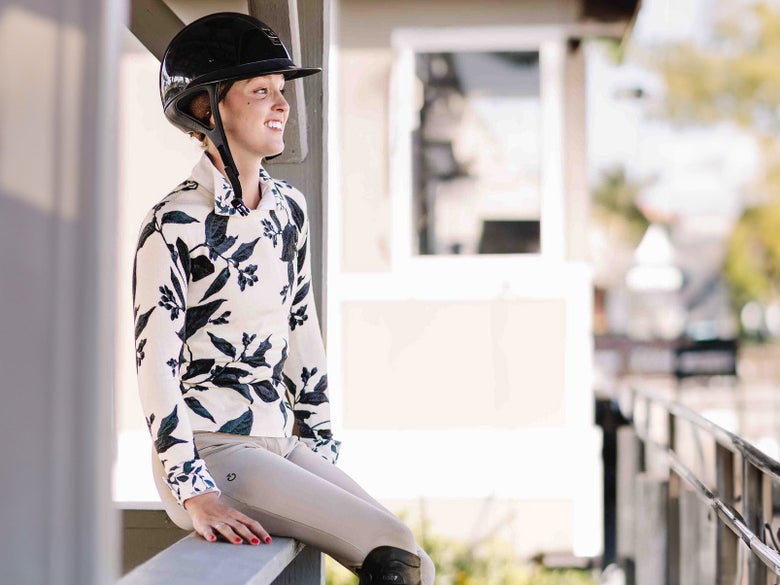 Rider sitting on a railing wearing a Kastel sun shirt.