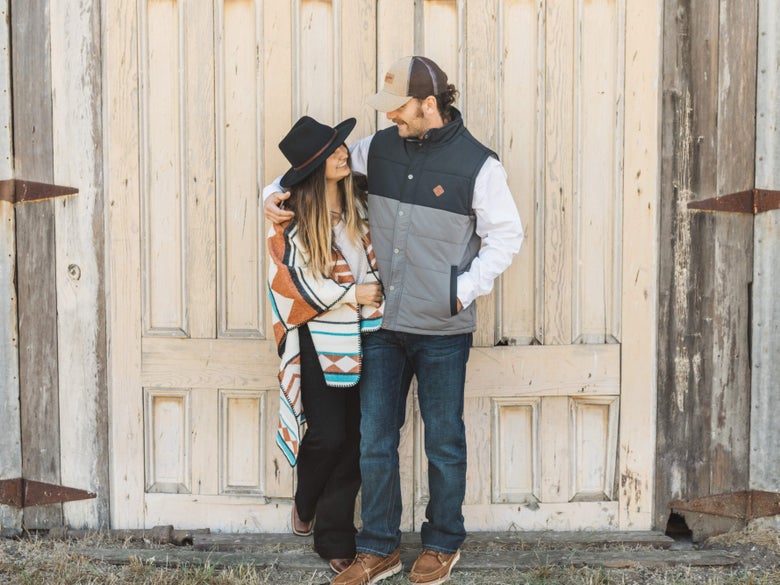 Man and Women embracing while wearing dark wash jeans