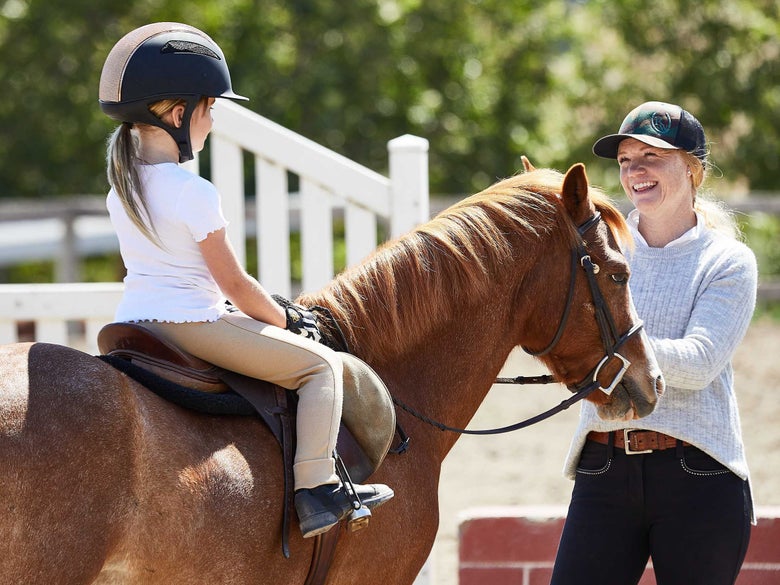 Riding instructor and student during a horseback riding lesson