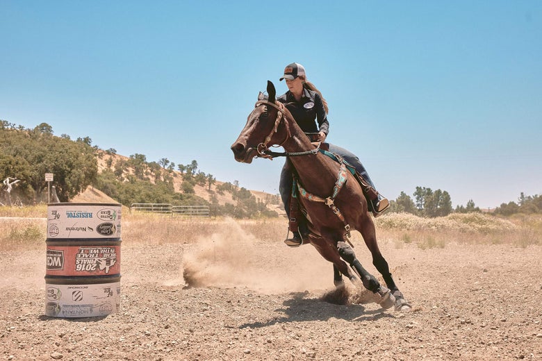 Barrel racer Krista Williams running her horse around a barrel.