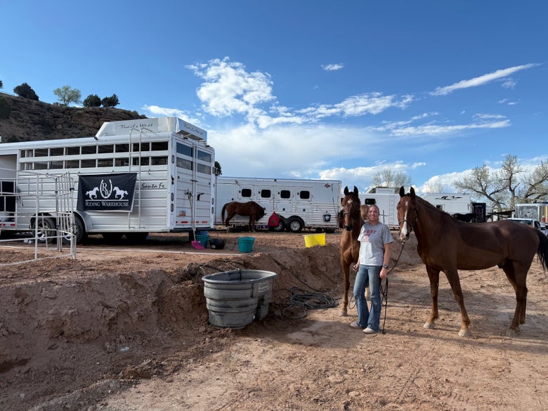 Natalie Law with two of her horses posing by her horse camp at Mount Carmel..