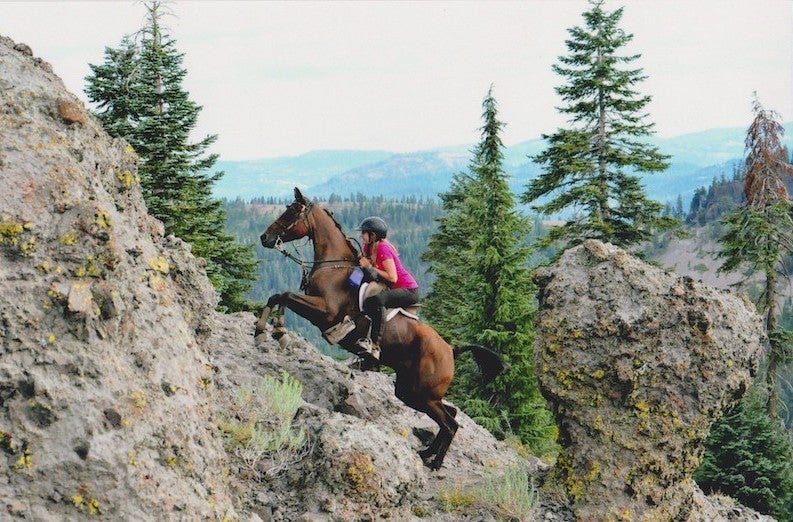 Sanoma riding her bay gelding up Cougar Rock at the Tevis Cup. 