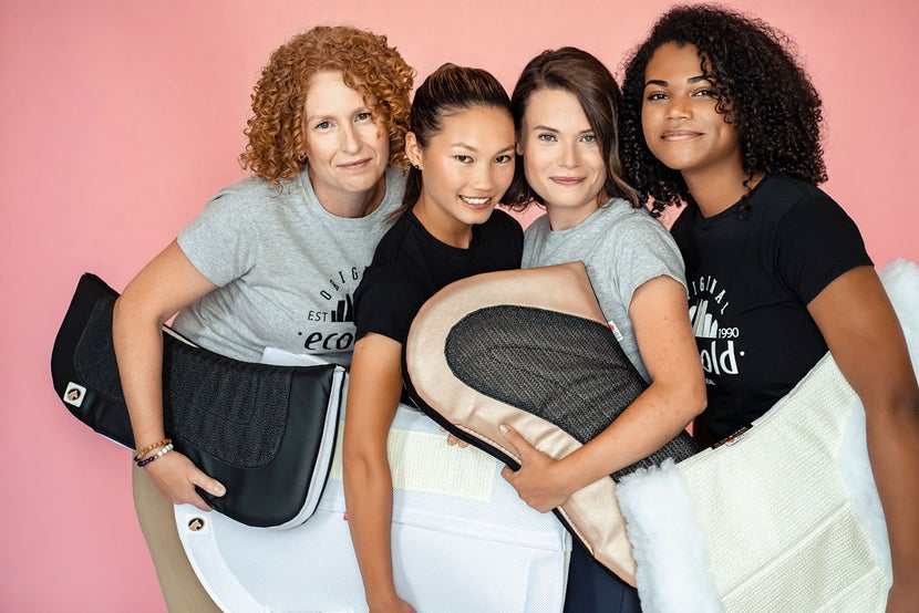 A group of girls all holding Ecogold saddle pads.