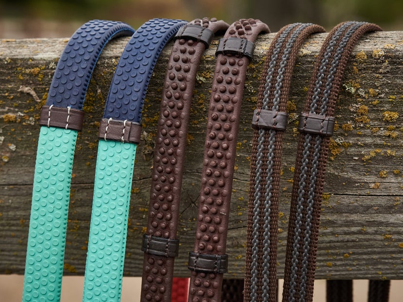 Rubber and web reins, side by side. Going from left to right: training reins, rubber reins, web rubber reins