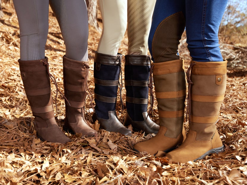 A group of women standing together, weariing different colors of the Dublin River III Women's Lifestyle Boots.