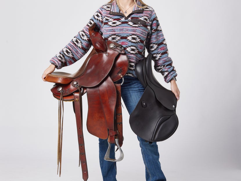 Woman standing with Western and English saddle on either hip. 