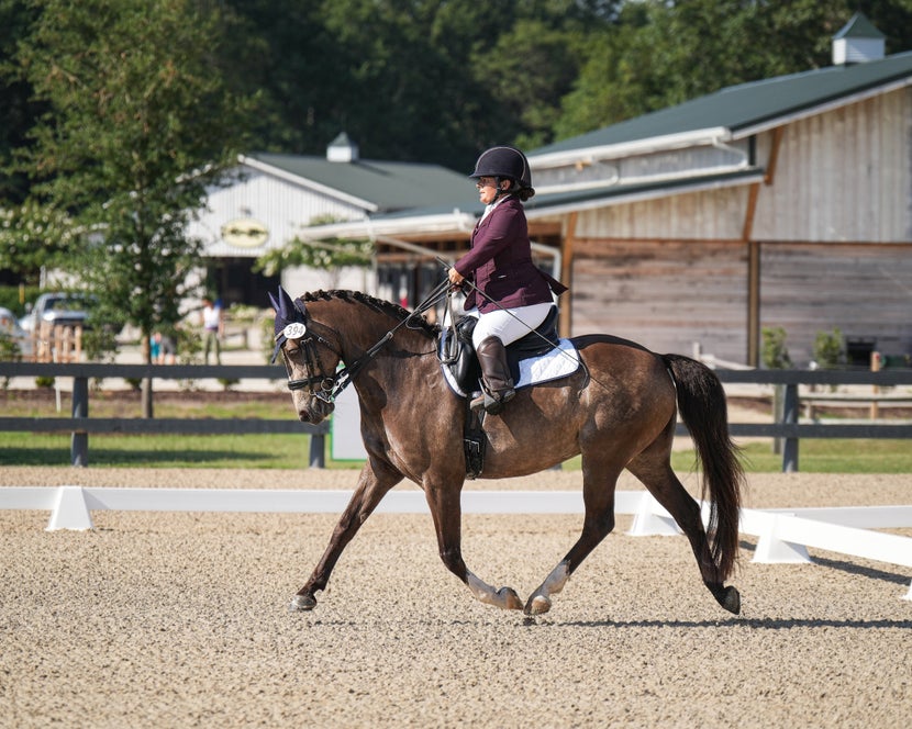 Meghan riding her pony in a Dressage test at a show. 