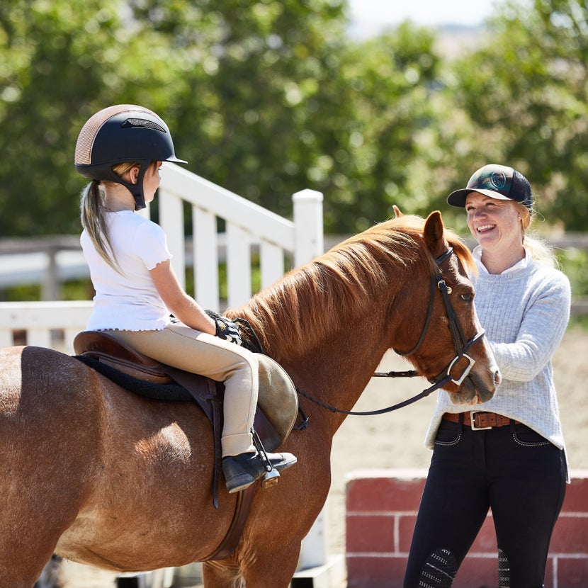 Riding instructor and student during a horseback riding lesson