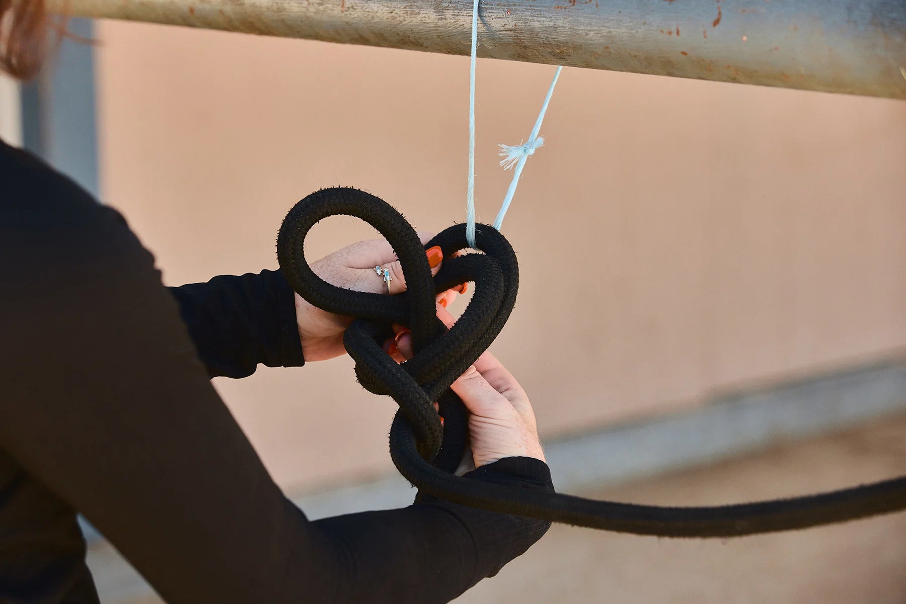 Pass under the end clipped to your horse, up through our circle loop and pull tight to create a knot.