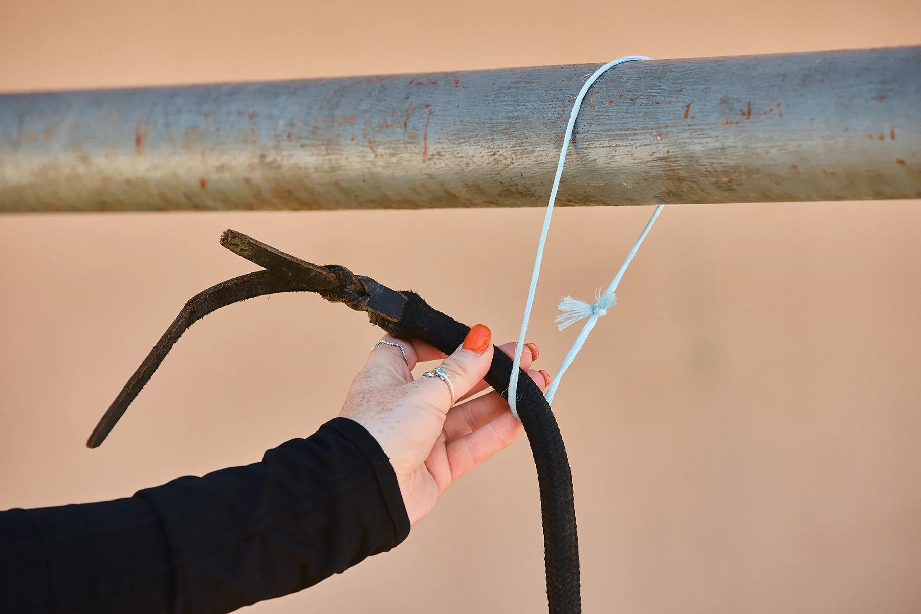 Take the tail end of your rope and put it over your rail or through your tie spot.