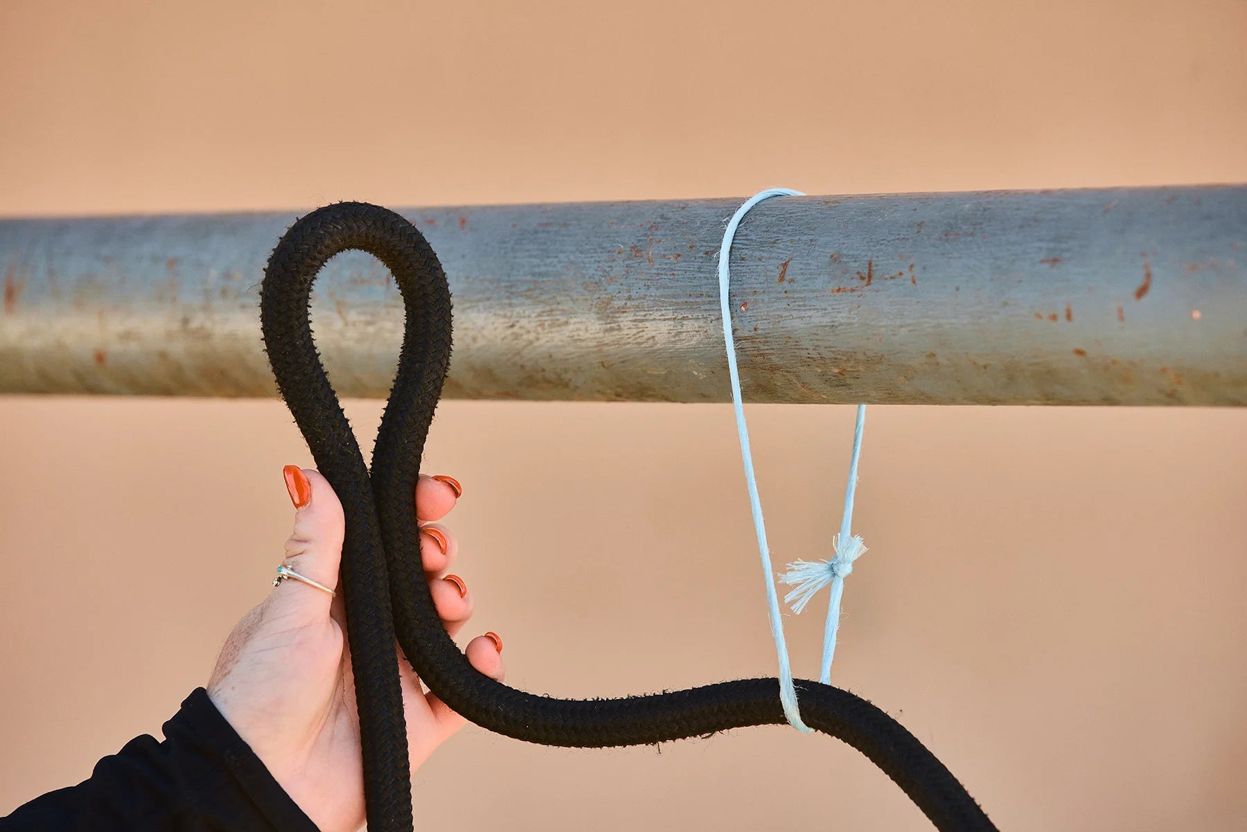 Pull it through until you have about 2 feet of rope between your horse and the tie spot. Working with the loose rope section nearest the tie spot, fold the rope to create a loop.