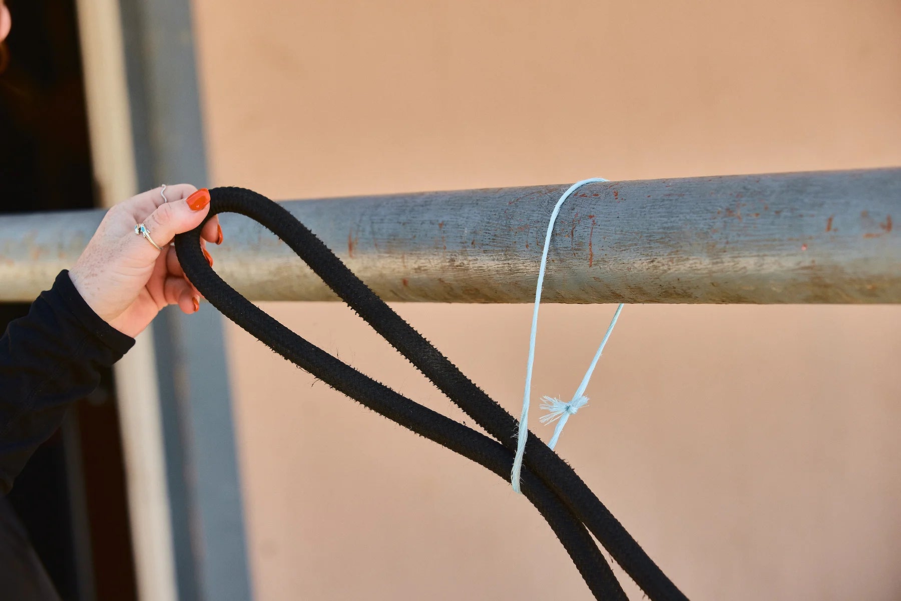 Loop your rope, leaving about two feet between the horse and the loop. Put your created loop over your rail or through your tie spot.