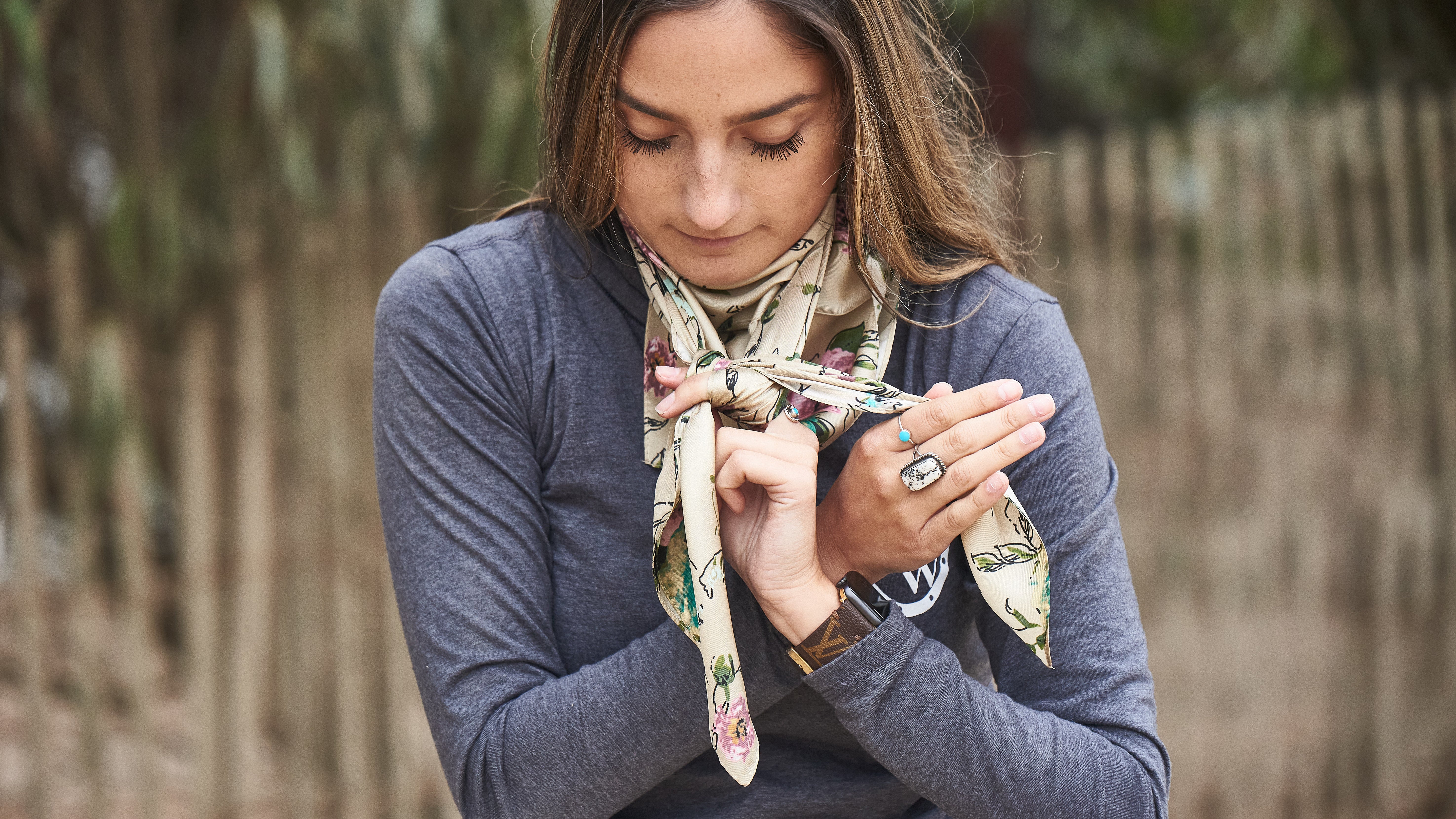 With the right piece in your right hand, slide the end all the way through the hole you have around your pointer finger. Bring the piece up and around your left hand, then back under to the right side.