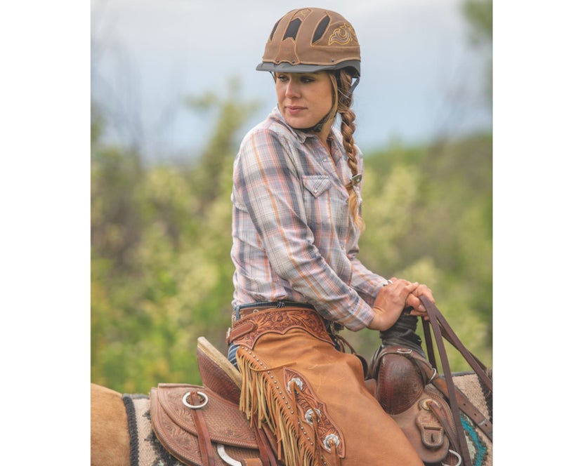 Woman on her horse wearing the Troxel Cheyenne Ultimate Western Riding Helmet.