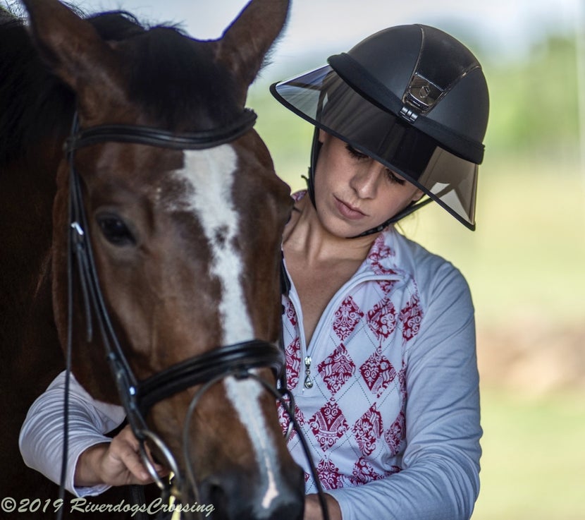 Woman equestrian wearing a clear-brim Soless Helmet Visor for UV protection