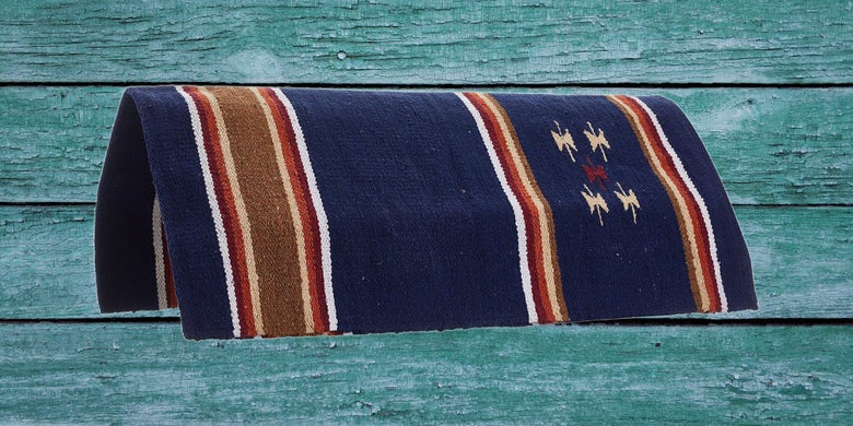 Reinsman Diamond R Navy Single-Weave Saddle Blanket on a teal wood background